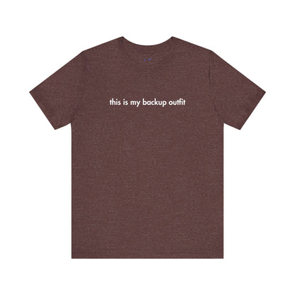 Brown t-shirt with white text 'this is my backup outfit' on a white background