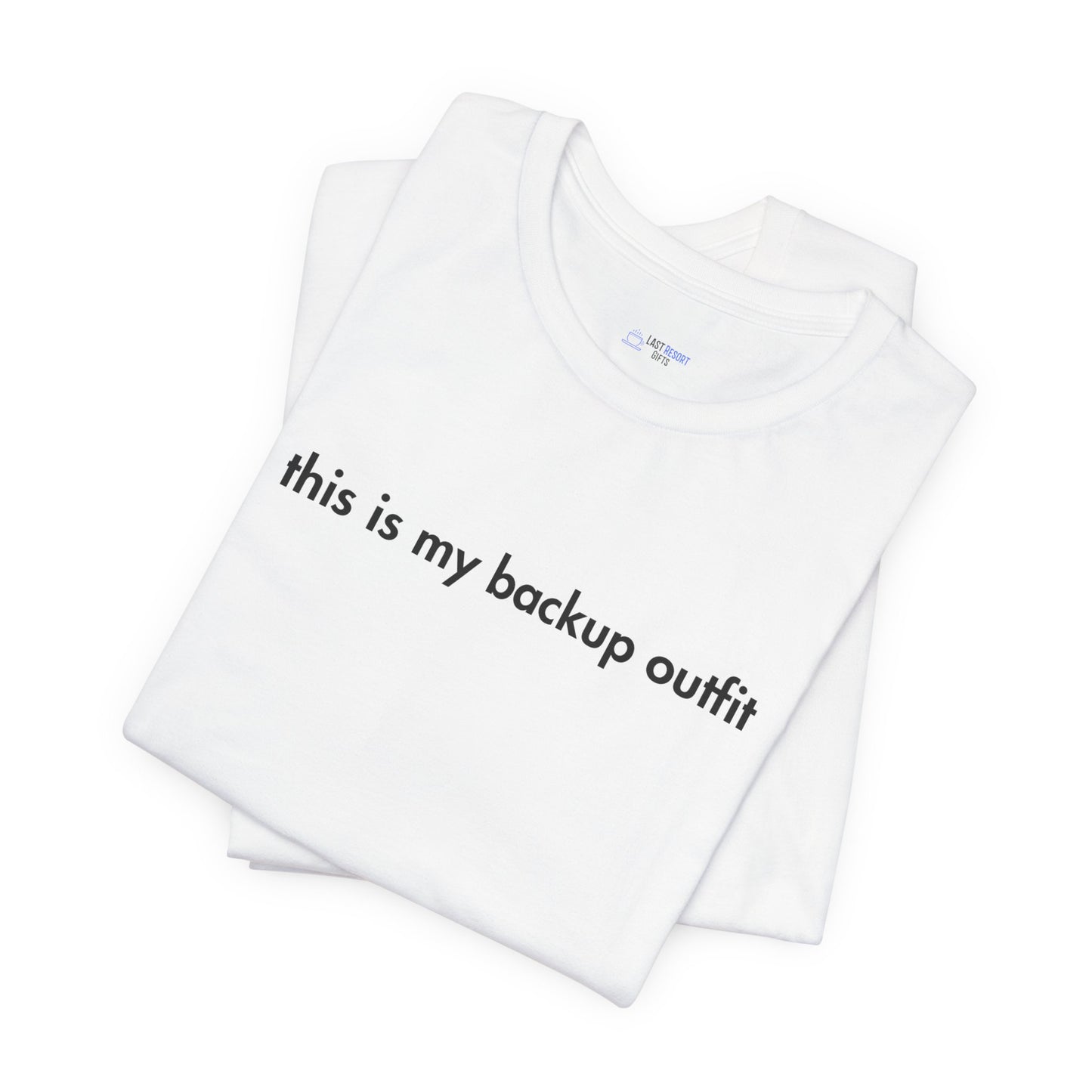 White t-shirt with text 'this is my backup outfit' on a white background