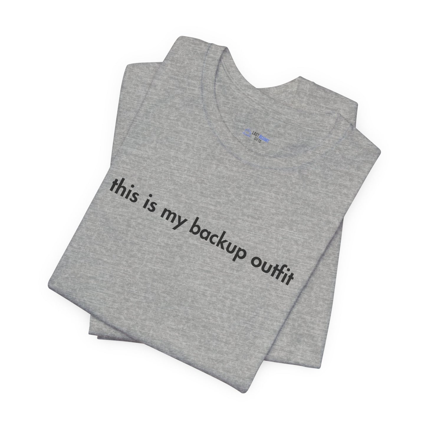 Folded gray t-shirt with text 'this is my backup outfit' on a white background