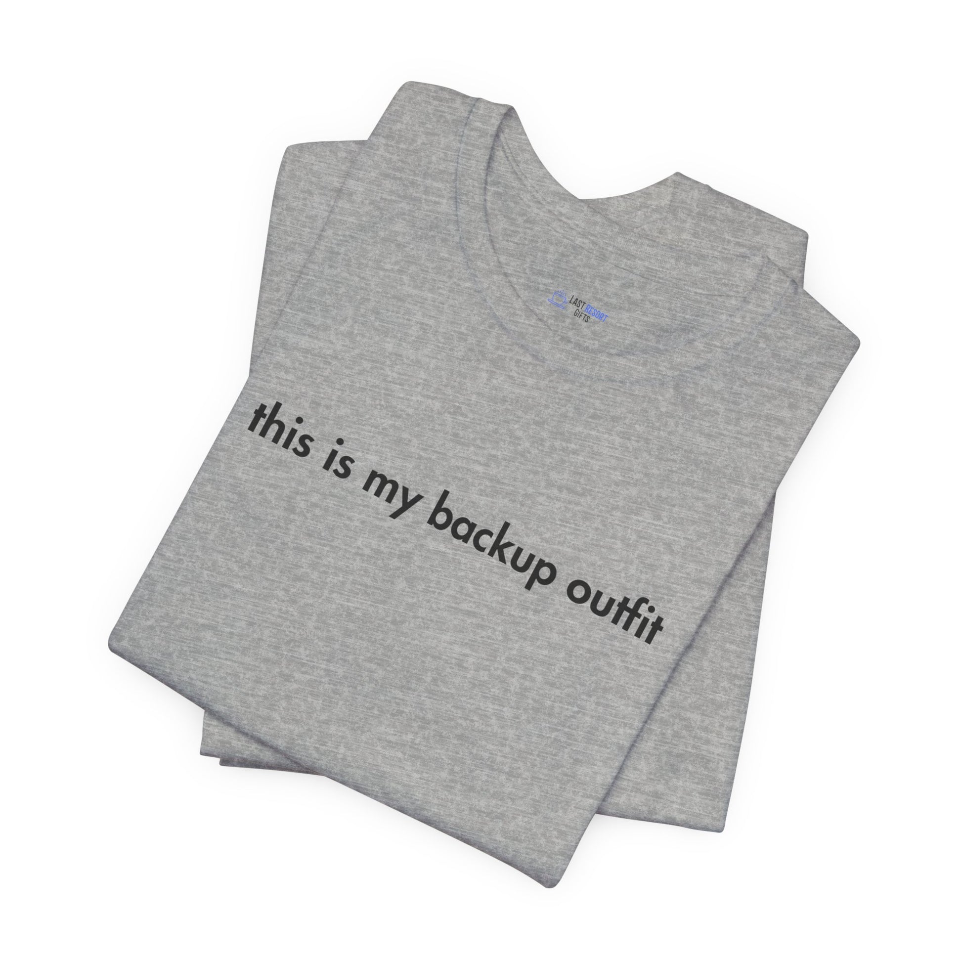 Folded gray t-shirt with text 'this is my backup outfit' on a white background